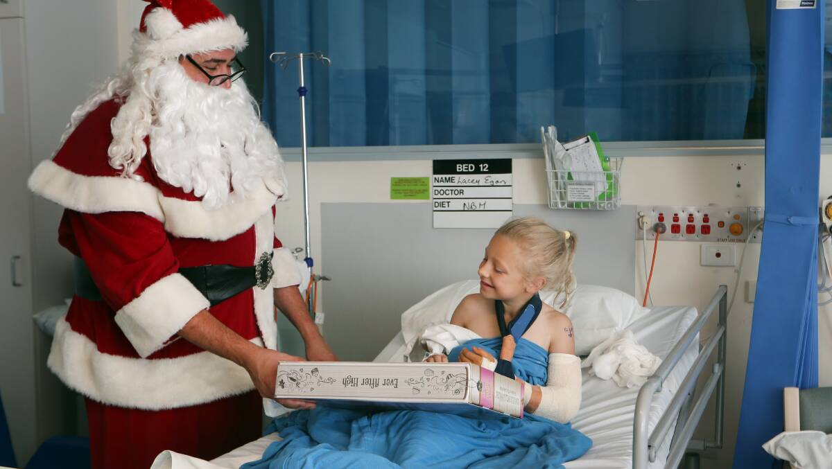 Festive spirit: Other kids were also buoyed by a visit from Santa, including eight-year-old Lacey Egan from Fairy Meadow. Picture: Sylvia Liber