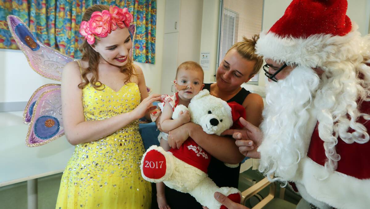 Welcome gift: Sophia Innis - pictured with her mother Courtney Rooke - got a surprise visit and a new teddy bear from the KidzWish Fairy and Santa at Wollongong Hospital on Wednesday. Picture: Sylvia Liber