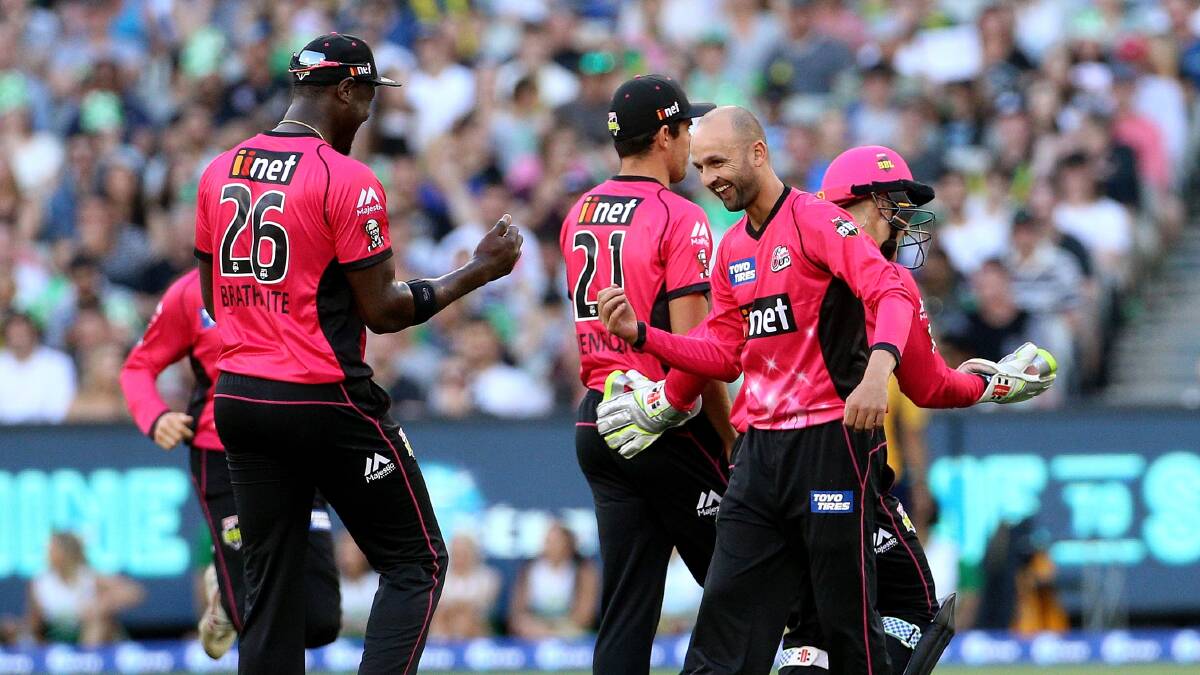 Nathan Lyon (right) celebrates with Sixers teammate Carlos Brathwaite after taking the wicket of Kevin Pietersen. Picture: AAP Image/Hamish Blair