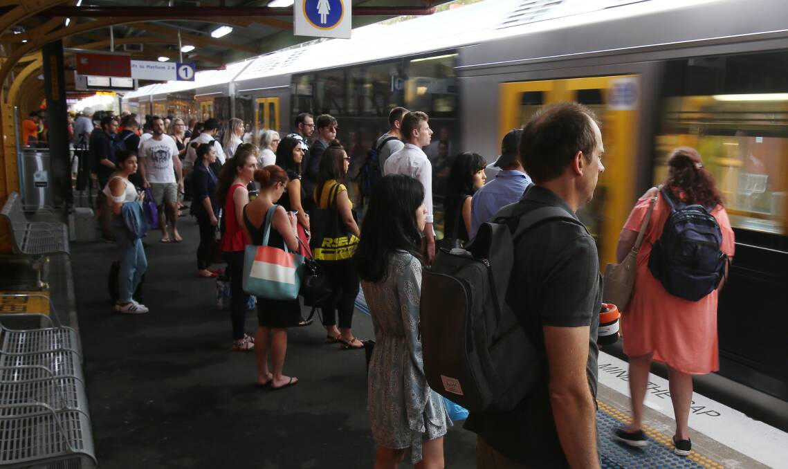 A throng of people wait at Wollongong station for one of the three morning peak hour services.