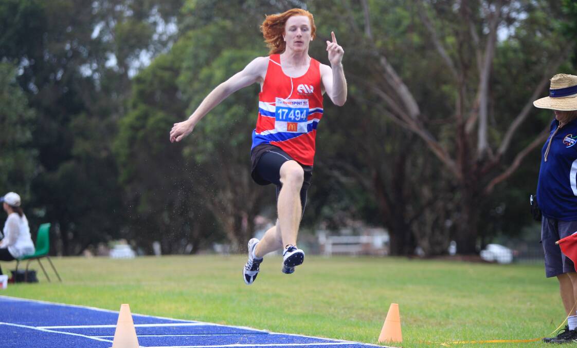 Taking flight: Wollongong's Austen Lantry in the triple jump at the NSW Country Athletics Championships. Picture: Georgia Matts. 