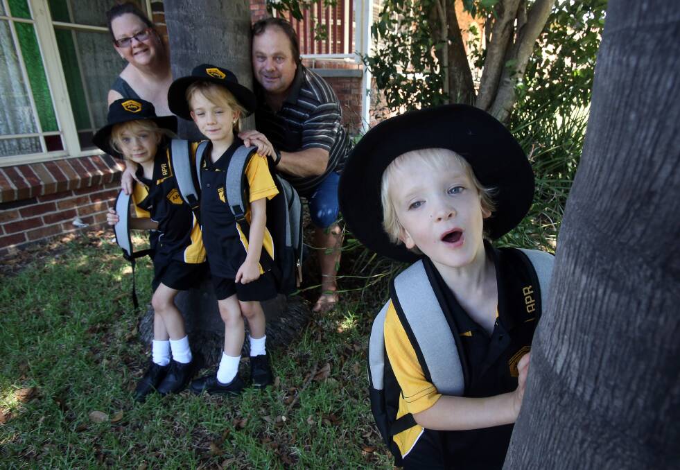 Sapphire, Brianna and Cooper Smith with their parents Sharon and Stephen Smith. The five-year-old Albion Park triplets are all set for their first day of school. Photo: Robert Peet