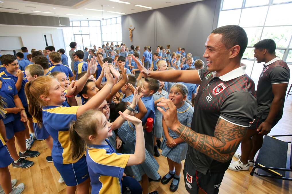 SUPERSTAR: Tyson Frizell meeting students during a visit to St Columbkille's Catholic Primary School in Corrimal. Pictures: Adam McLean