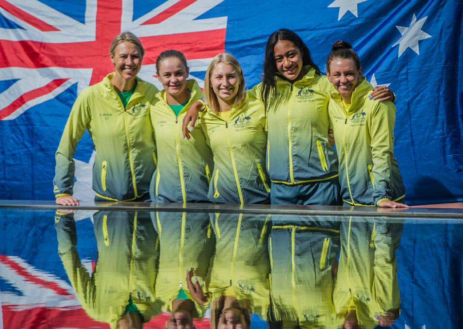 Group hug: Australia's Alicia Molik, Ash Barty, Daria Gavrilova, Destanee Aiava and Casey Dellacqua beat the Ukraine in Canberra to make it to the final World Group qualifier in Wollongong next month. Picture: Karleen Minney. 