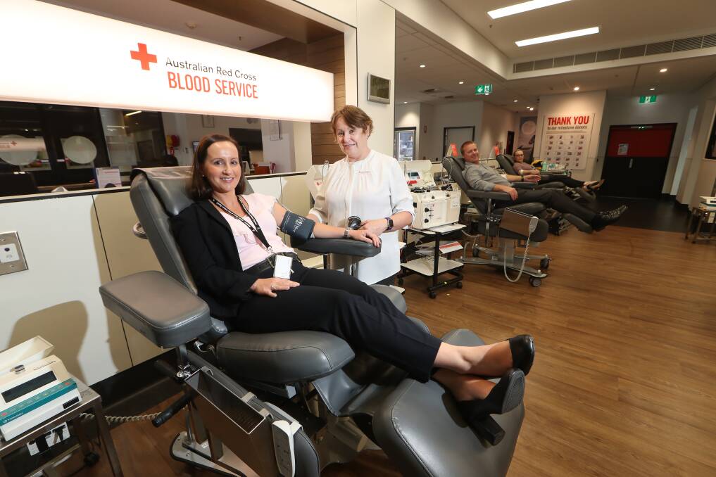 Rolling up: Wollongong Donor Centre nurse Deborah Berry assists Detective Senior Constables Nicole Spouszta, Graham Lockhart and Louise Goldstraw as they give blood as part of a police campaign. Pictures: Sylvia Liber