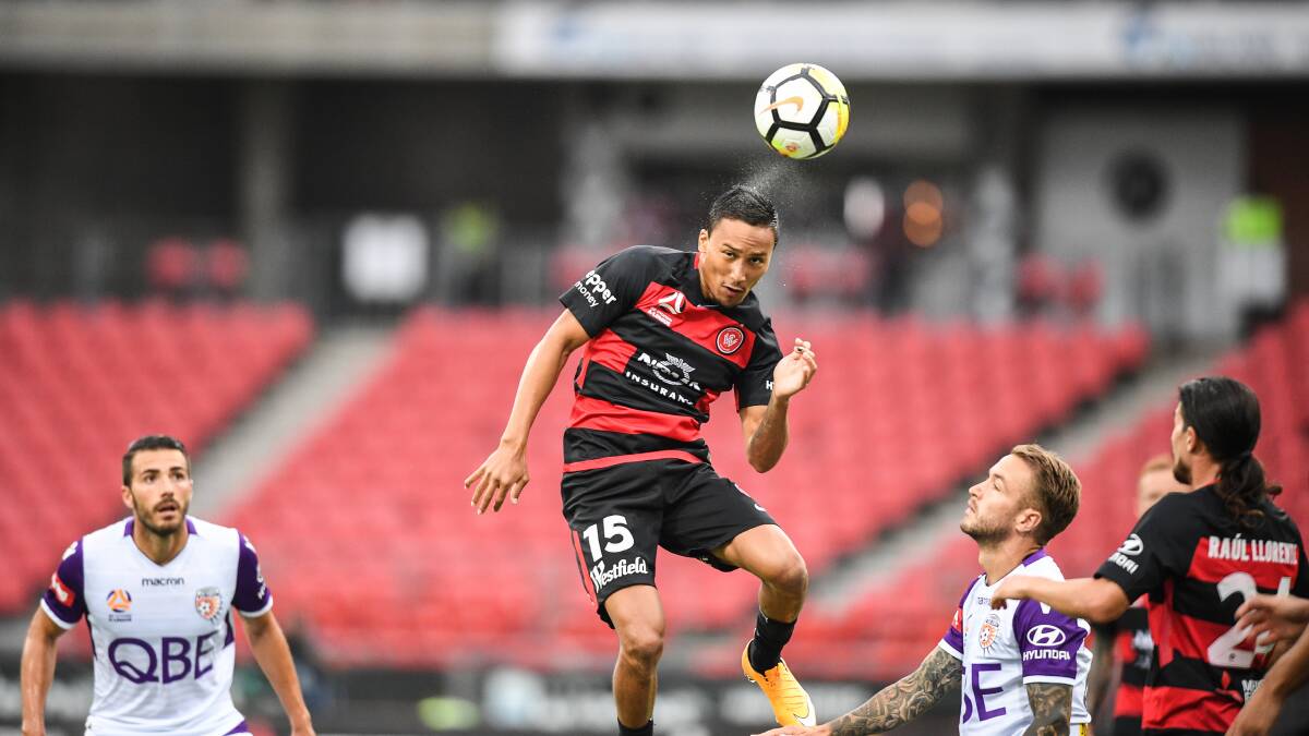 FINAL PUSH: Kearyn Baccus of the Wanderers heads the ball against Perth at Spotless Stadium. Picture: AAP Image/Brendan Esposito
