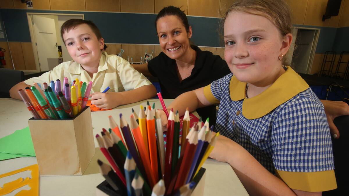 BEFORE AND AFTER SCHOOL CARE: Centacare coordinator Julianne Chaplain with St Francis of Assisi Catholic Parish Primary School students Seth Madden and Paige Madden. Picture: Robert Peet
