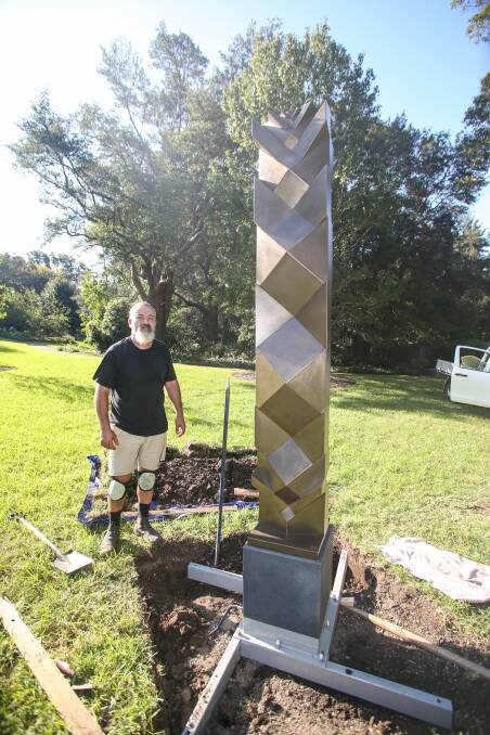 Fatih Semiz with his work 'Perpetuity', painted steel at the Sculpture in the Garden biannual event at Wollongong Botanic Garden. Picture: Georgia Matts