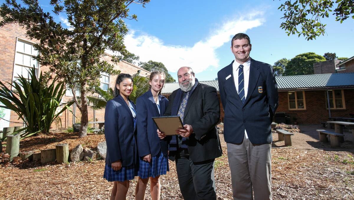 HIGH ACHIEVERS: Corrimal High School principal Mark King with students Vanessa Marcelo, Brittney Zulian and Declan Weir-Nash. The school has been praised for its sustained HSC success. Picture: Adam McLean
