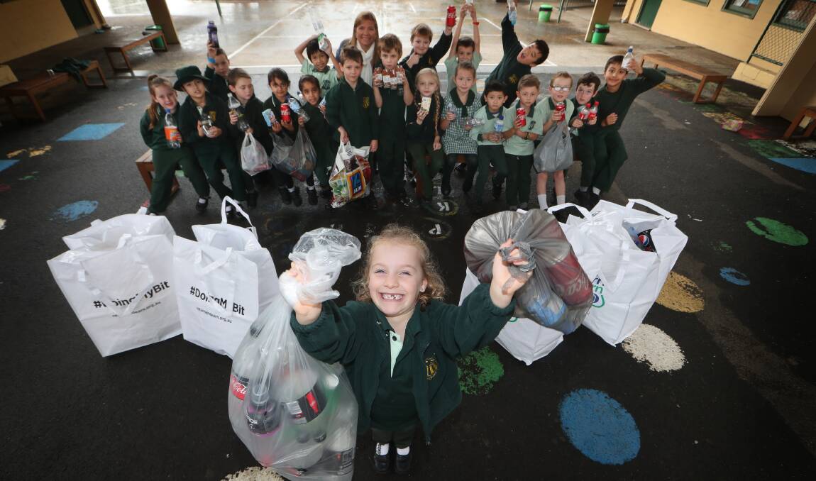 HELPING HANDS: Mount Ousley Public School student Penelope Thompson has had help from fellow students to recycle cans and bottles as part of a fundraising drive for Forever Projects charity. Picture: Sylvia Liber
