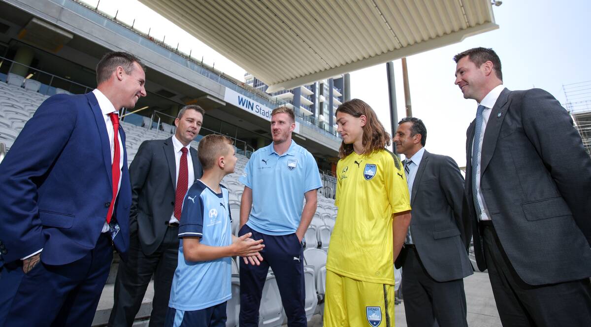 AGREEMENT: Wolves coach Luke Wilkshire and Chris Sheppard (far left) and Sydney FC chairman Scott Barlow (right). Picture; ADAM McLEAN