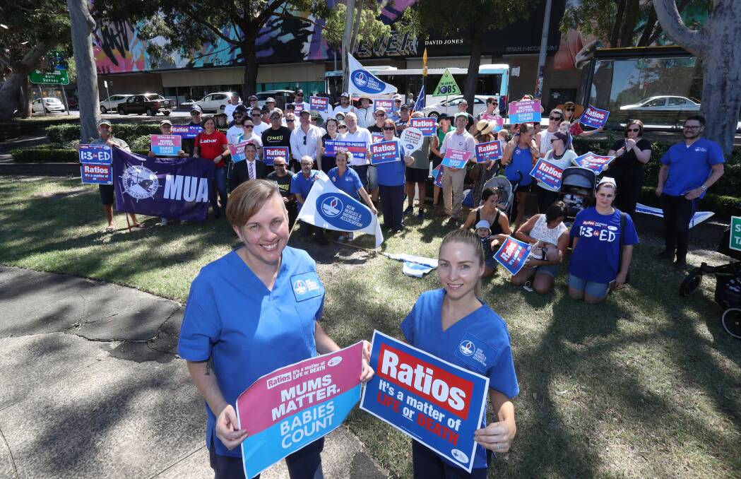 Ongoing campaign: NSW Nurses & Midwives Association members Emma Gedge and Kayla Freytag in front of the crowd at the Rally for Ratios in MacCabe Park on Tuesday. Picture: Robert Peet