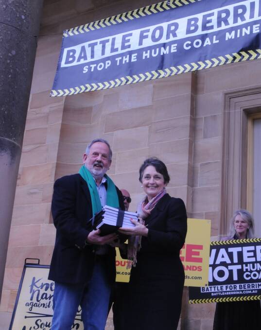 Heavy message: Ken Wilson handing over the petition to Member for Goulburn Pru Goward in Berrmia earlier this month. Picture: Lauren Strode
