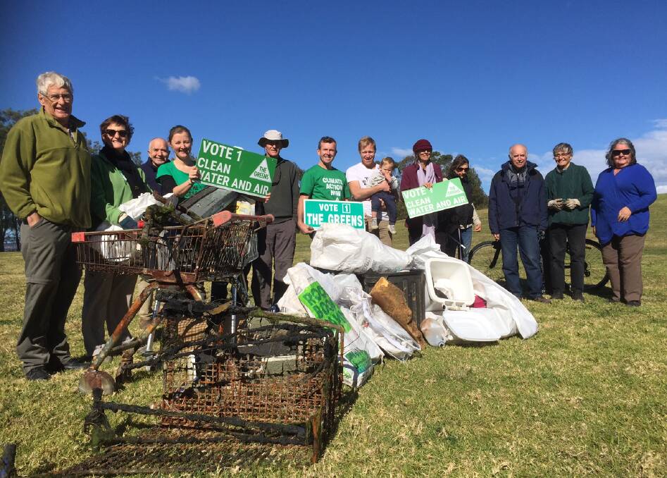 Shocker: Greens Ward 3 council candidate Jamie Dixon (centre) with volunteers and some of the rubbish collected at the lake. 
