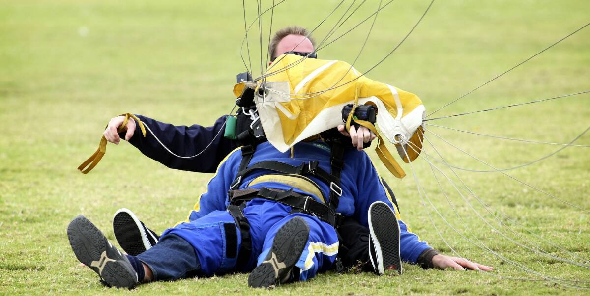 Where to now: A tandem skydive ends safely on the grass in Stuart Park, North Wollongong, one of many who land there regularly with Skydive the Beach.
