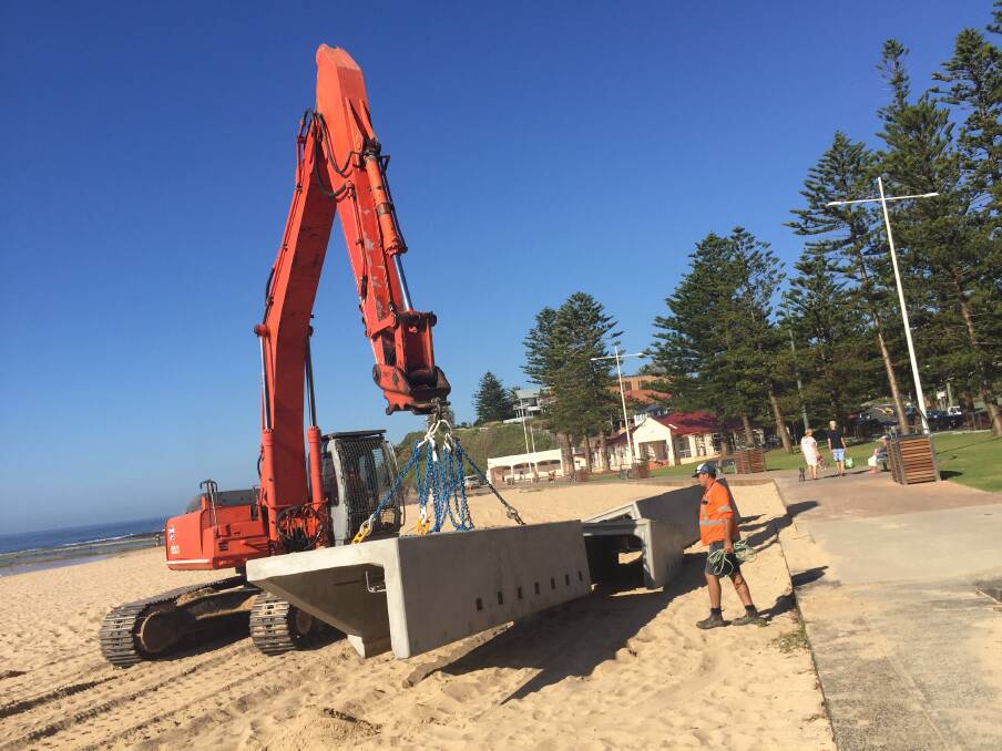 LOCK AND LOAD: The seven-tonne pre-cast concrete cappings are taken to storage until the next low tides in April. Picture: BEN LANGFORD