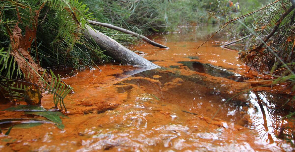 Orange alert: The bright colour in the water catchment creek comes from iron oxide pollution. Pictures supplied by Lock the Gate.