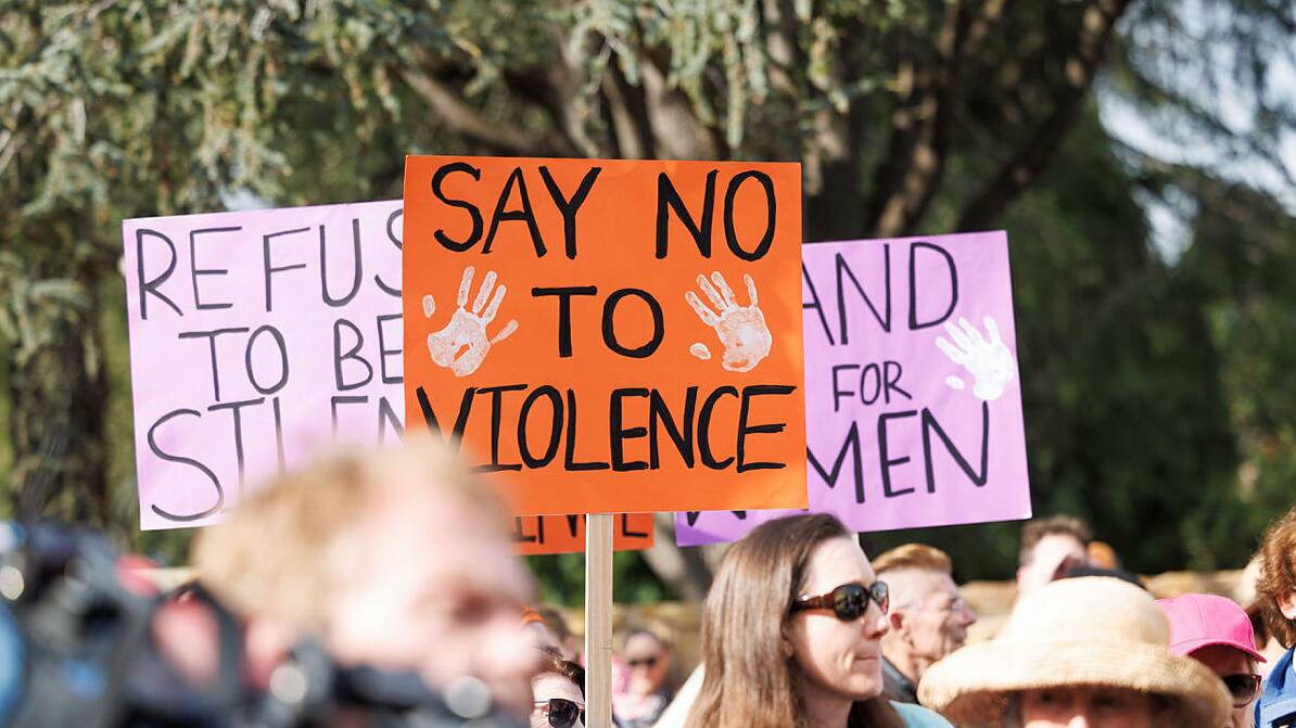 Signs at a rally against gendered violence. Picture by Keegan Carroll