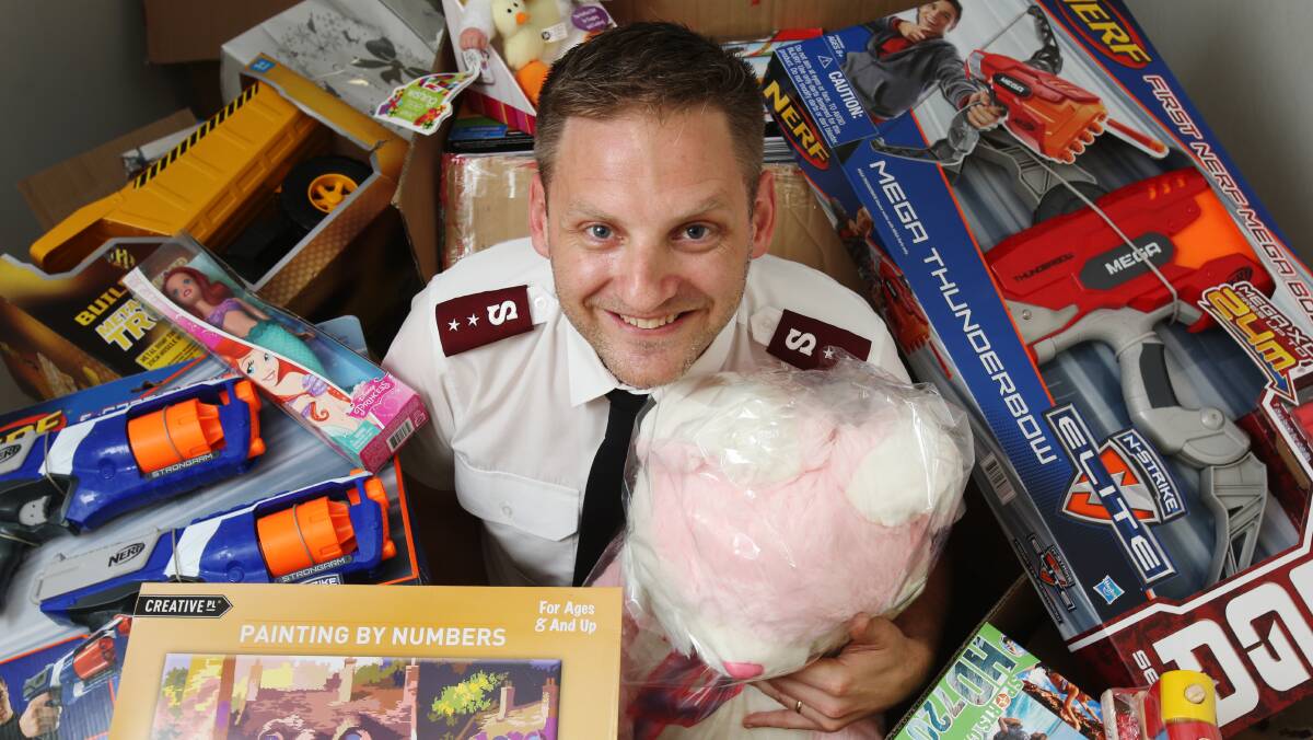 Helping hand: Wollongong Salvation Army Captain Phil Inglis with some of the gifts already collected for the 2015 Christmas toy drive which helps struggling families. Picture: Robert Peet