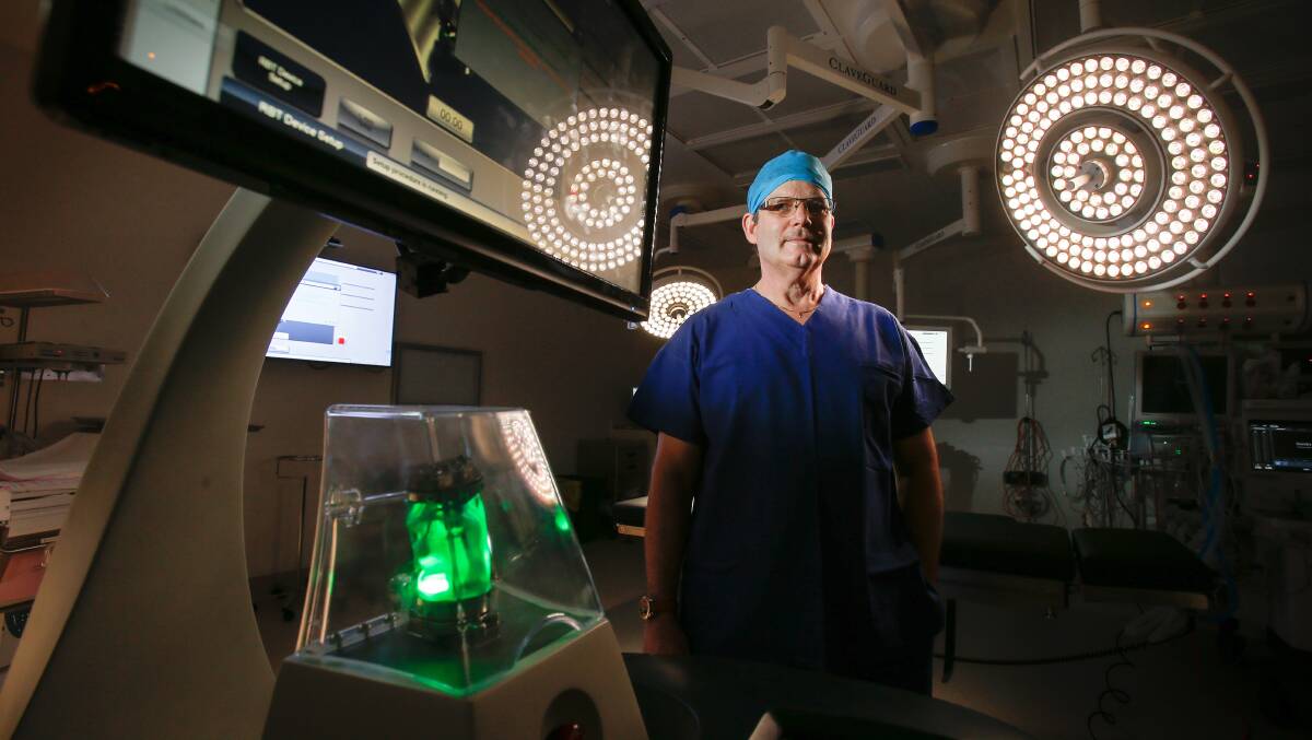 State-of-the-art: Wollongong neurosurgeon Dr Jerry Day with his new assistant at Wollongong Private Hospital - the Mazor Robotics Renaissance Guidance System. Picture: Adam McLean