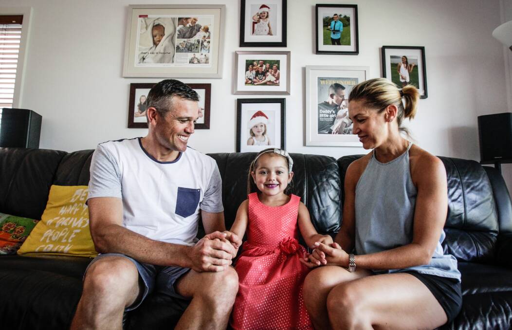 Power of love: West Wollongong parents Andrew and Sharon Gilmour with their daughter Payton, 5, who is thriving after being born with a life-threatening condition. Picture: Georgia Matts