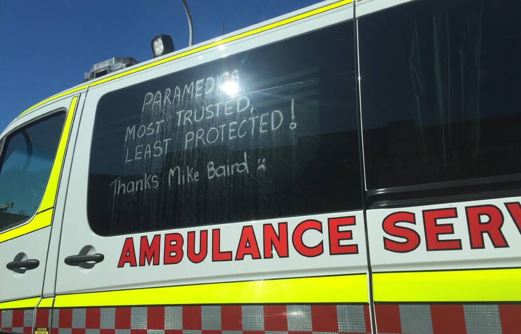 An ambulance spotted in Crown Street, Wollongong this week featured the slogan 'Paramedics. Most trusted, least protected', as part of the protest against cuts to cover. Picture: Adam McLean