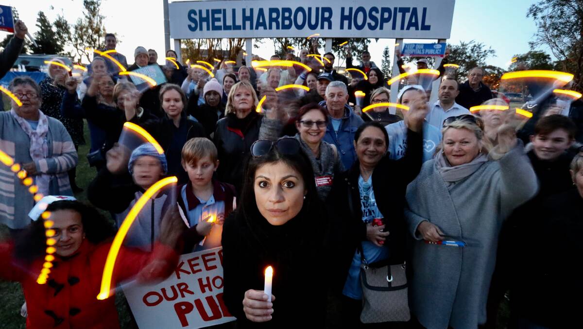 KEEP IT PUBLIC: Shellharbour and Port Kembla Public Hospitals Community Group coordinator Irene Hatzipetros (front) with residents and staff at Thursday evening's candlelight vigil. Picture: Adam McLean