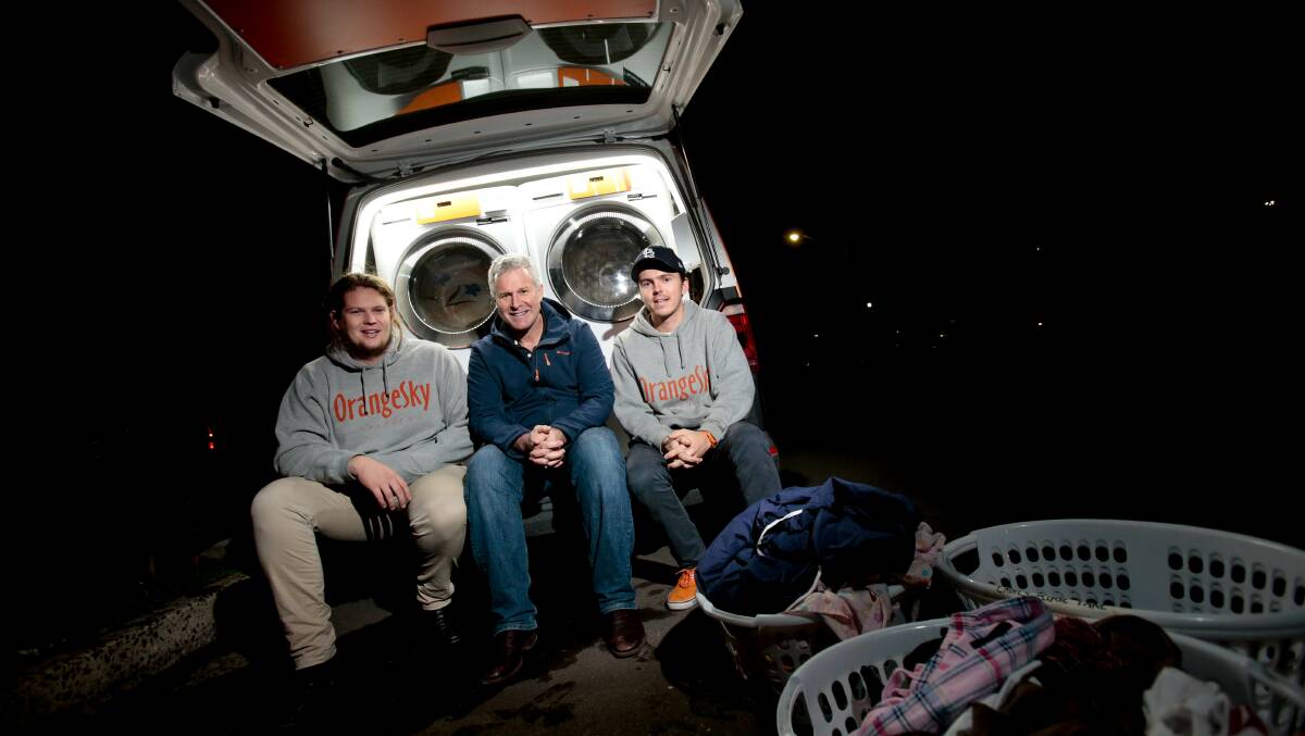 Orange Sky Laundry founders Lucas Patchett and Nic Marchesi with Dr Bruce Ashford in Warrawong earlier this month. Picture: Adam McLean