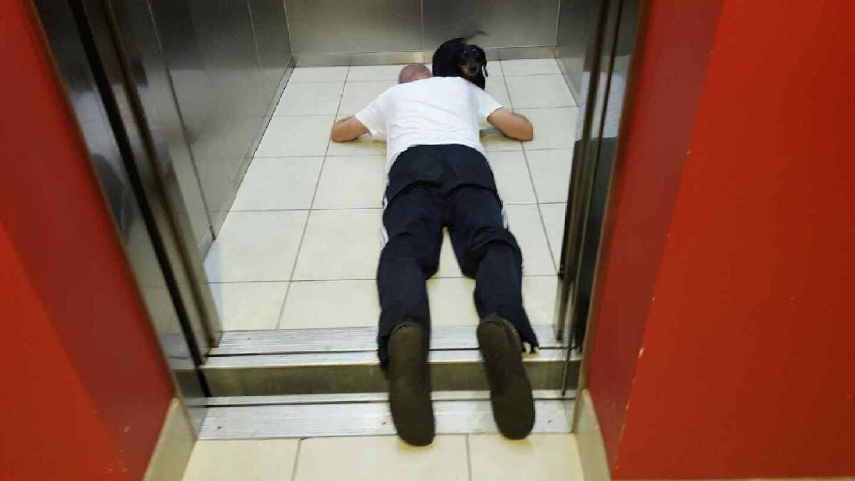 A neighbour took a photo after David Sait fell into the lift due to a malfunction which caused it to stop at an uneven height. Picture: Supplied