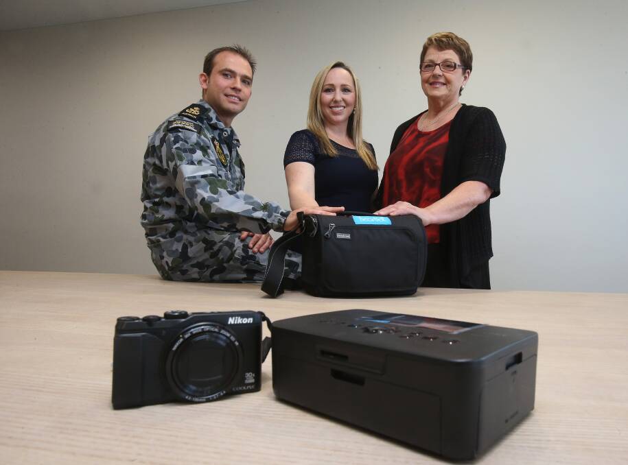 Precious gift: Nicole and Brad Akhurst hand over the camera pack to Wollongong Private Hospital bereavement midwife Jeanette King. Picture: Robert Peet