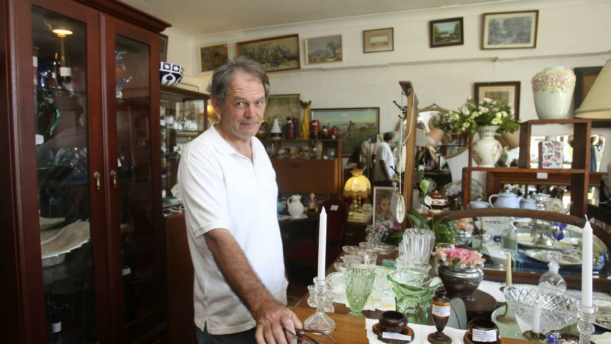 Treasure trove:  Paul Azzopardi looks right at home in the interior of his shop, surrounded by glassware, antique furniture and all sorts of vintage odds and ends.