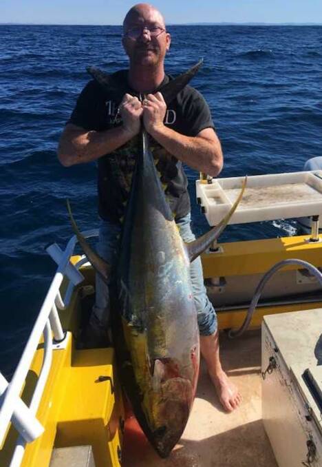 What a beauty: Tony Woods with his yellowfin tuna caught trolling off Jervis Bay last week.