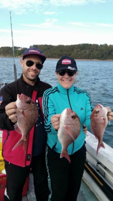 Aussie fish dinner: Spanish visitors Antonio Barea and Vanesa Garcia enjoyed their holiday with cousin Greg Barea and a feed of snapper.