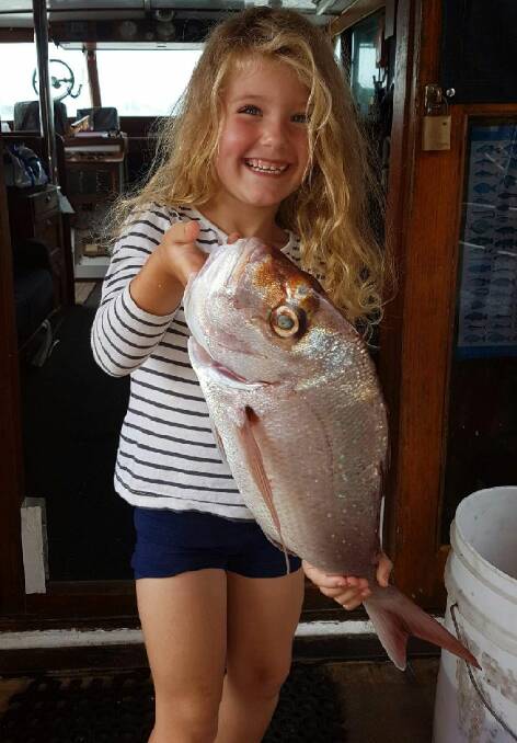 Great catch!: Petite four-year-old Summer Renee is all smiles after catching this snapper during a Signa Charter from Kiama.