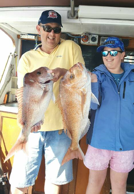 Country visitors: Ryan and Jonah Mugridge from Young with a nice pair of snapper caught on a recent charter with MV Signa out of Kiama.