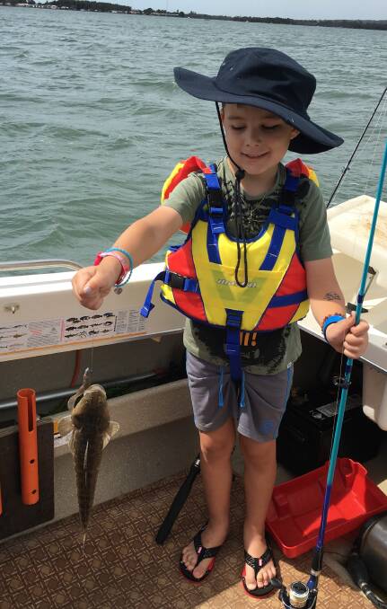 A flathead first: Five-year-old Kaiden Murphy with his first ever flatty he caught in Lake Illawarra.