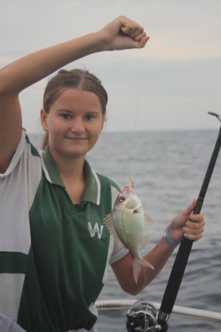 Back you go: Maddison Hall from Warrawong High School with a snapper.
