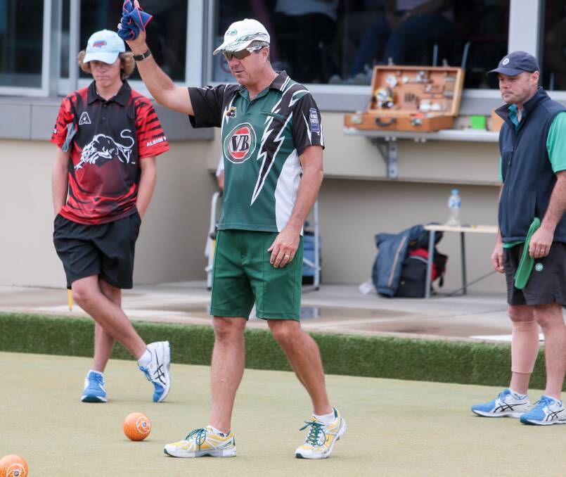 Champ: John Green (centre) calls the shots during his rink's win over Corrimal's Jarrod Beckford (left) in the fours final.  Picture: ADAM McLEAN