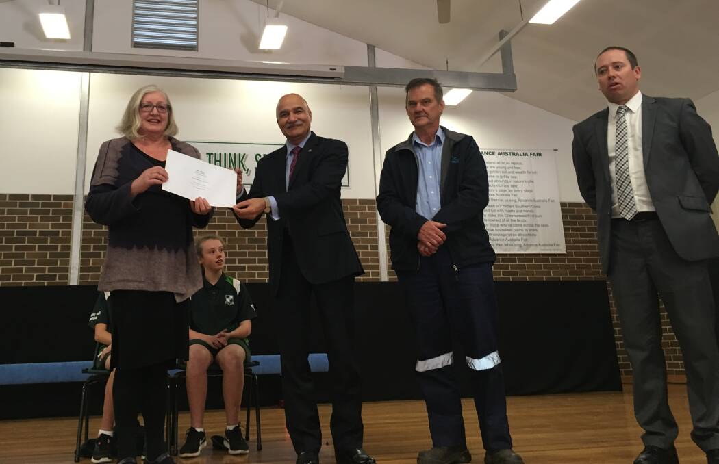Russell Vale Public School P&C president Pamela Anderson accepts the $5000 cheque from Wollongong Coal CEO Millnd Oza.