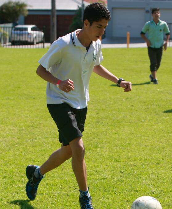 KICK AROUND: Kamal Issa from Warrawong High School playing football at the Illawarra Multicultural Youth Conference. Picture: Georgia Matts 