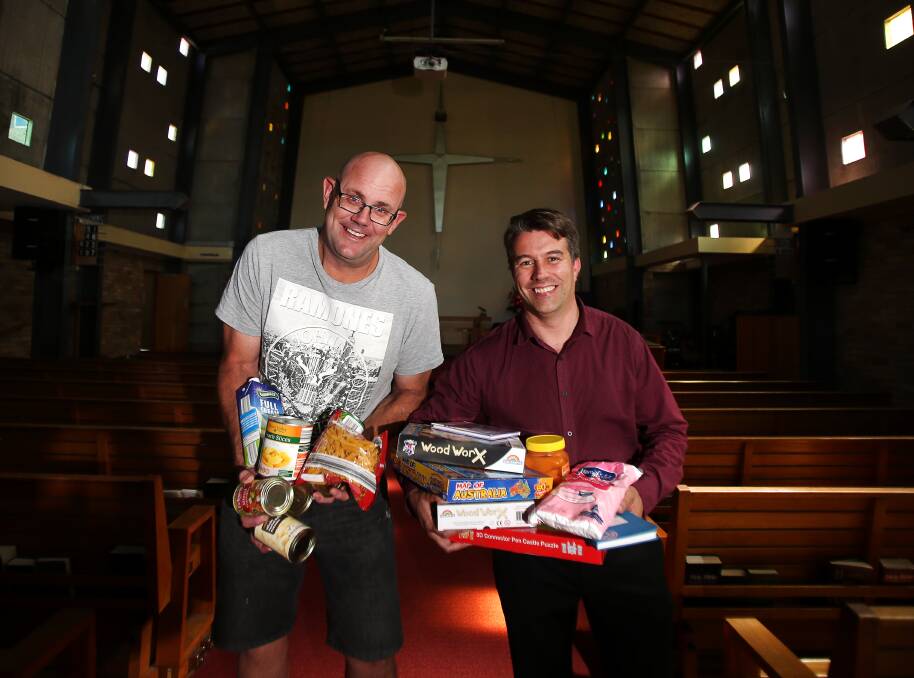 DONATIONS: Scott Stark and St Mark’s West Wollongong senior minister Peter Hutchinson want food and toys for Anglicare's Toys 'n' Tucker. Picture: Sylvia Liber