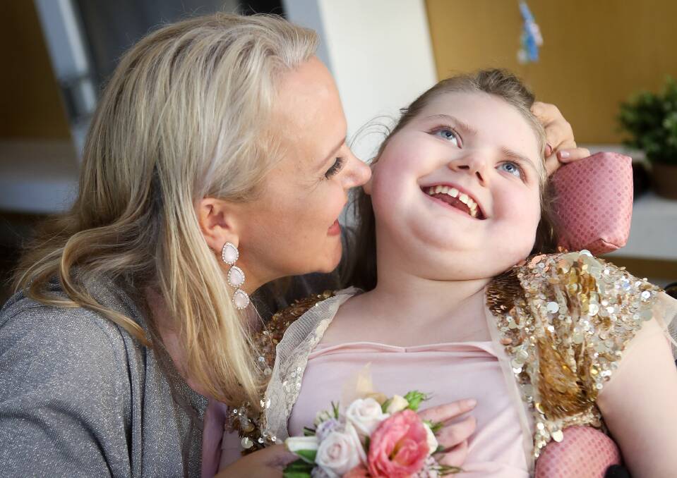 REASON TO CELEBRATE: Susan Wallis and daughter Gracie. A high tea was held to celebrate the 12-year-old graduation from Para Meadows School. Picture: Adam McLean