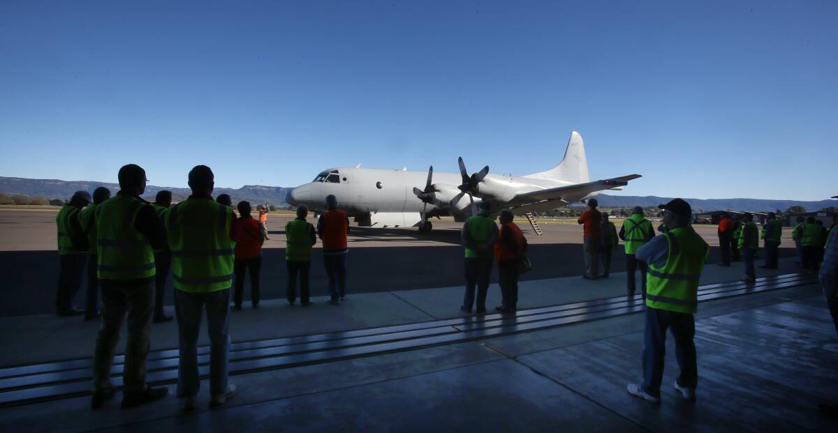 INTERESTED ONLOOKERS: Keen aviation types and HARS visitors check out the P3 Orion. 
   