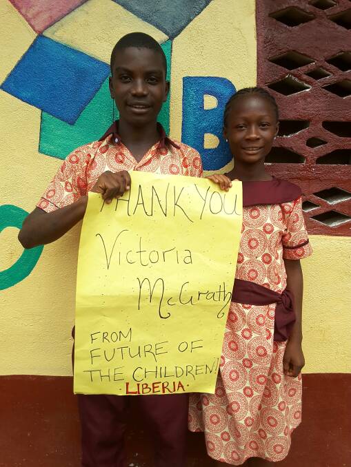 APPRECIATIVE: Students thank a donor for sponsoring a teacher for a year. As little as $1.40 a day is all that's needed to pay the wages of a trained teacher in Liberia.