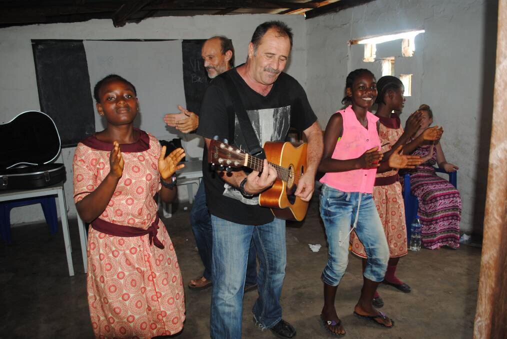 MR ENTERTAINER: Mick Fernandez works in public health but the passionate Wollongong musician also found time to entertain children in West Africa.