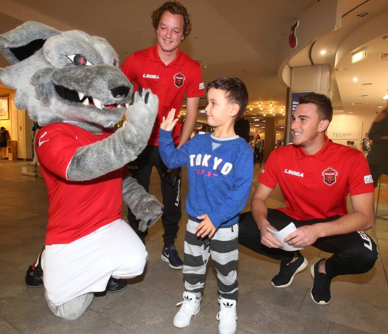 HIGH FIVE: Rafael Golaboski, 5 gets acquainted with Wolves' mascot and players Luke Foster and James Baldacchino. Picture: Robert Peet.