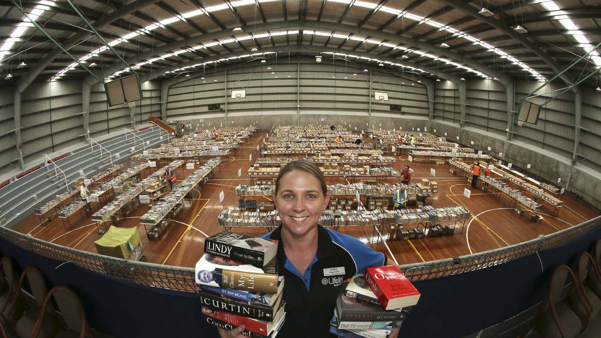 THIS YEAR' S BIGGER: This photo from last year's Big Book Fair features Claire Leslie Lifeline. This year The Illawarra Sports Stadium at Berkeley has been decked out and filled with books. Picture: KIRK GILMOUR