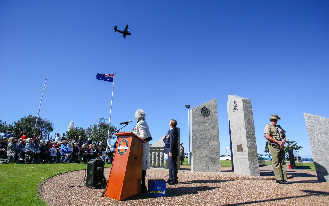 Maureen Patch and Ian Birch watch as a Caribou aircraft performs a fly over during the Vietnam Veterans memorial service and commemoration of the 50th anniversary of the Battle of Long Tan at Flagstaff Hill. Picture: Adam McLean