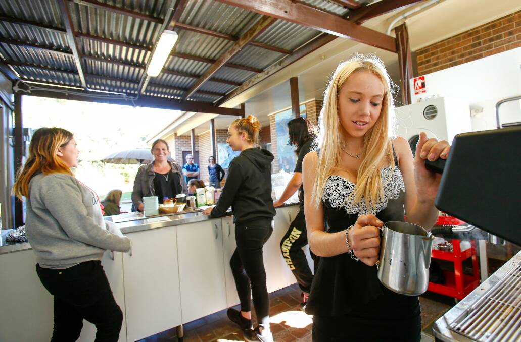 COMMUNITY LINKS: Corrimal High School student Brearna Ashford, 15, makes a coffee in the community cafe that has been started by students participating in the Bellambi Links to Learning program. Picture: Adam McLean