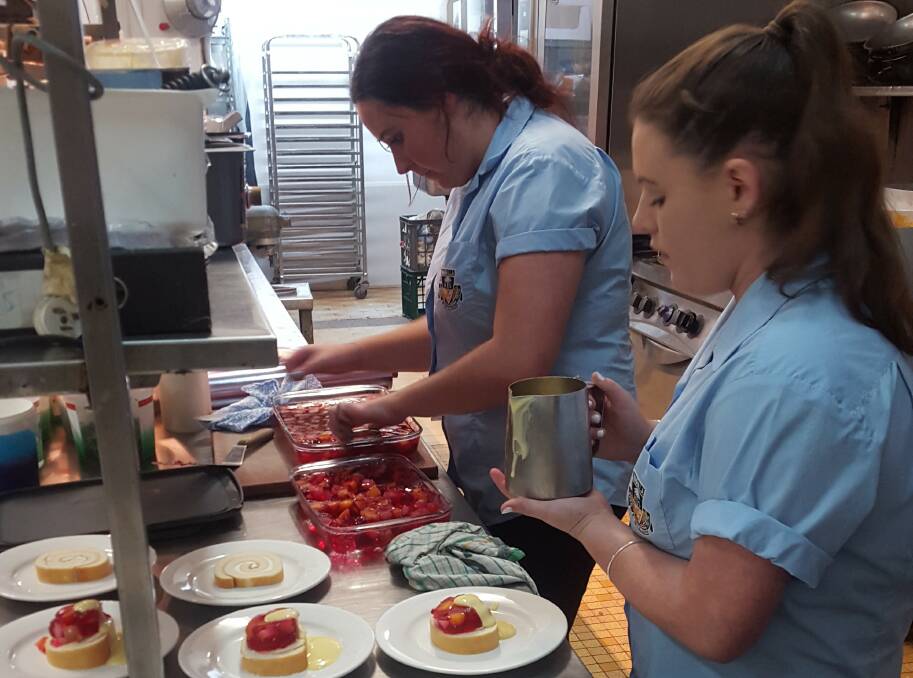 PREPARATION: Warilla High School Year 11 LEAP program students ​Sarah Ramsay and Abbie Coomber get to work preparing lunch in the Panorama House kitchen. Picture: Supplied